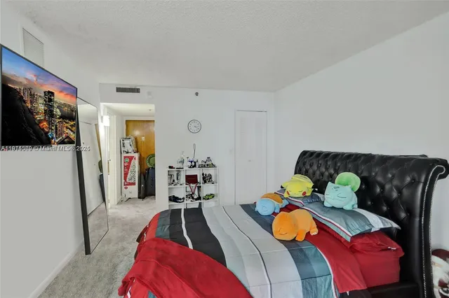 a bedroom with two beds and painting on the wall