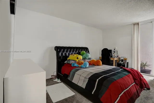 a bedroom with bed and a couch