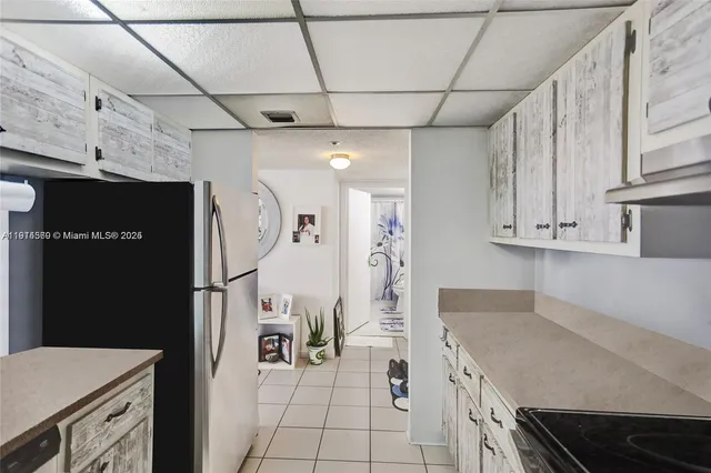 a kitchen with stainless steel appliances a refrigerator and a stove