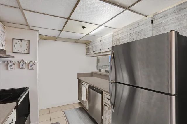 a kitchen with stainless steel appliances granite countertop a refrigerator and a stove