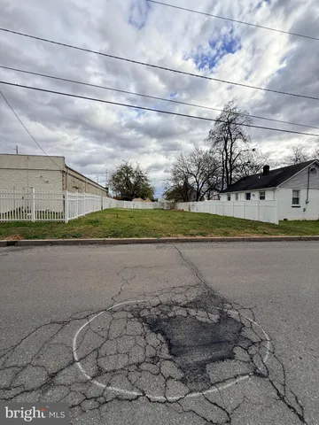 a view of a yard with wooden fence