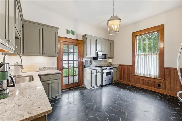 a kitchen with a stove a sink and a refrigerator