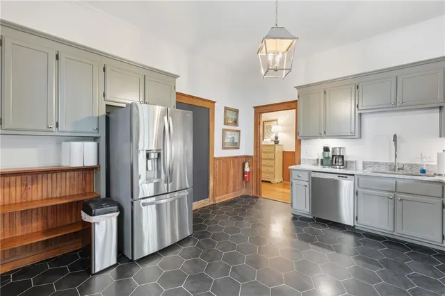 a kitchen with stainless steel appliances granite countertop a refrigerator and a sink