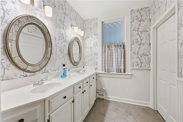 a bathroom with a sink a mirror and a toilet
