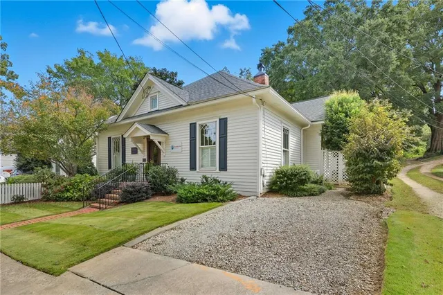 a front view of a house with garden