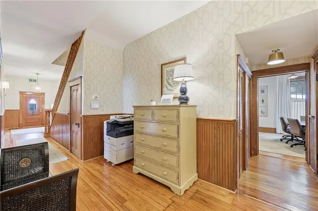a kitchen with a refrigerator and wooden floor