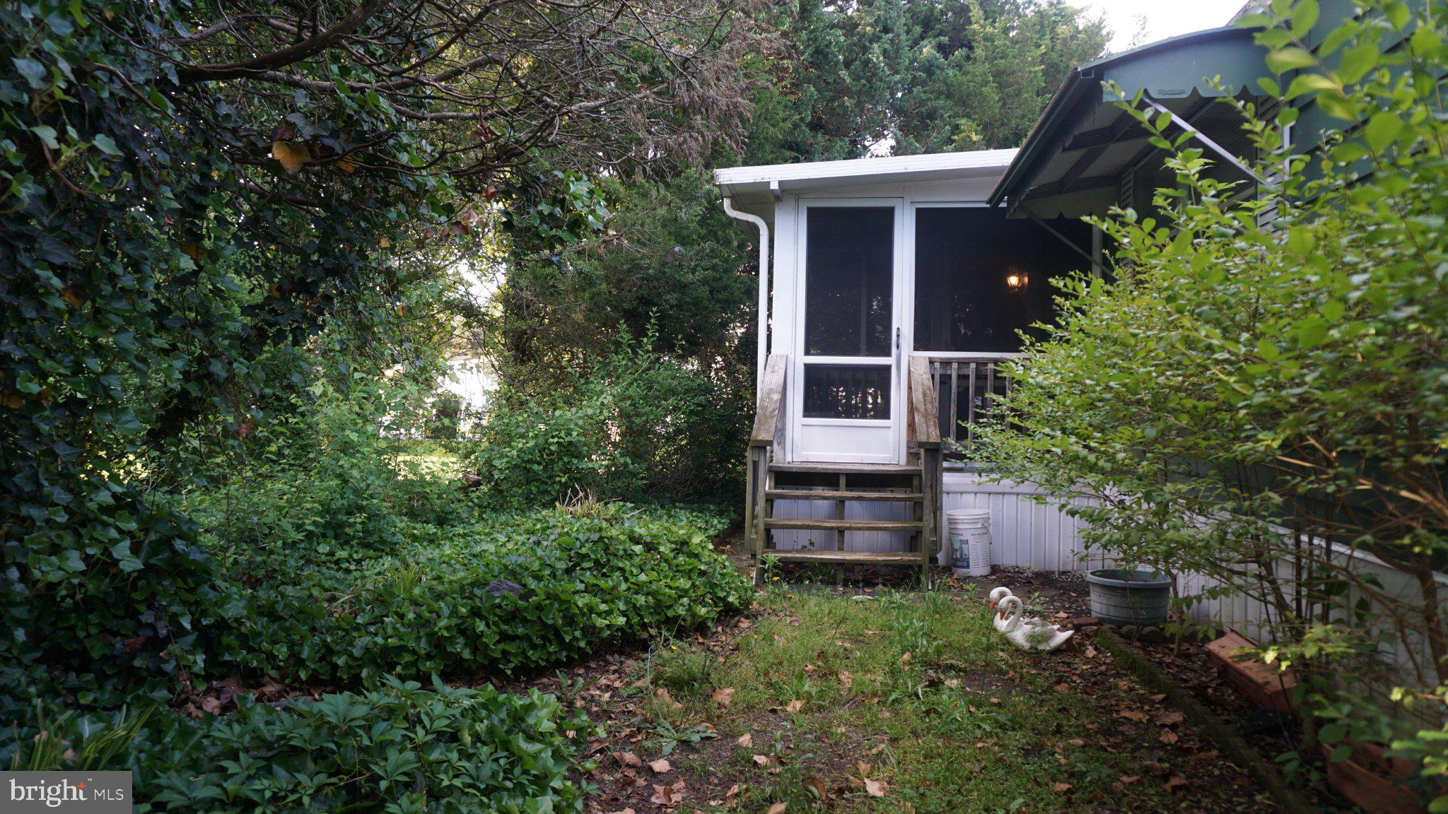 107 Country Lane Buena, NJ 08310 - Photo 3 of 6 a view of a house with a yard and plants