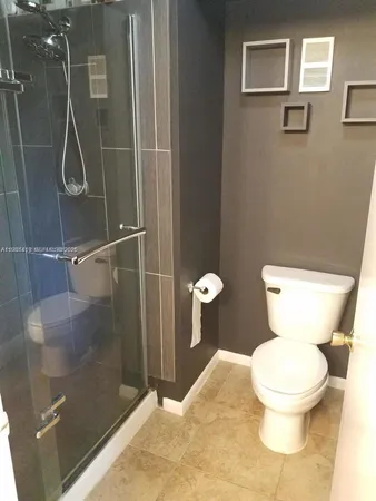a bathroom with a toilet and a shower
