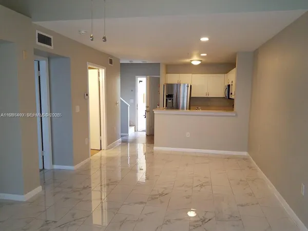 a view of a hallway with wooden shelves