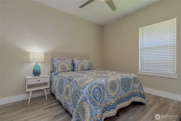 a bed sitting in a bedroom next to a window