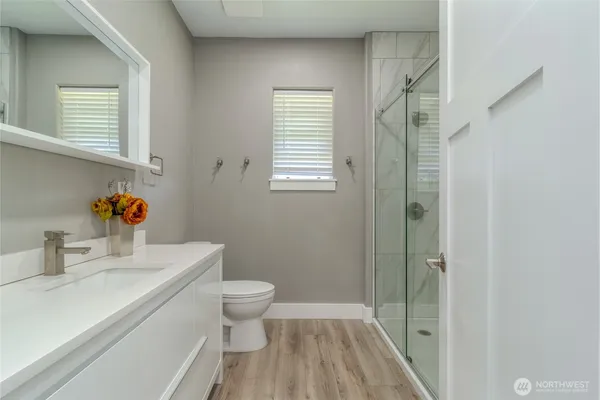 a bathroom with a sink toilet and shower