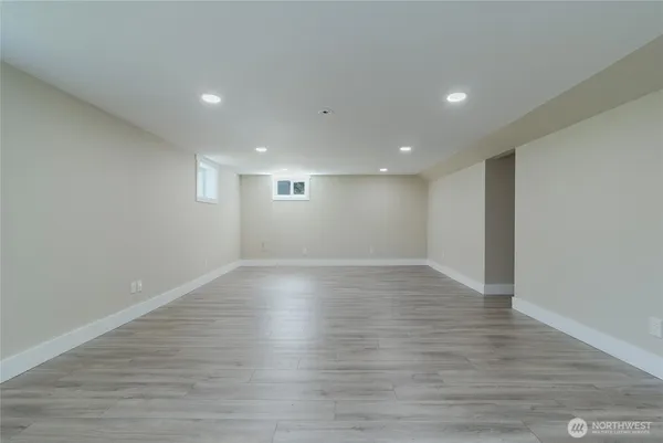 a view of empty room with wooden floor