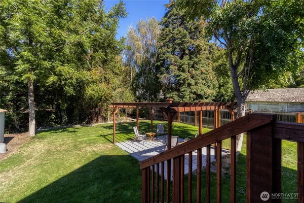 a view of a wooden deck with a big yard