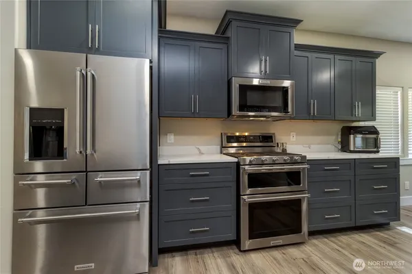 a kitchen with stainless steel appliances and wooden cabinets