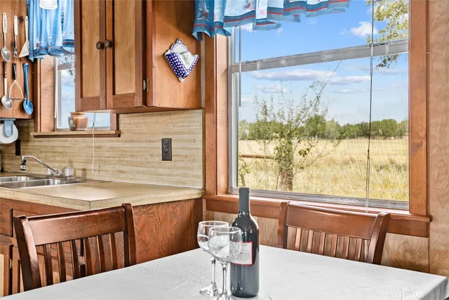 a view of a dining room with furniture a chandelier and wooden floor
