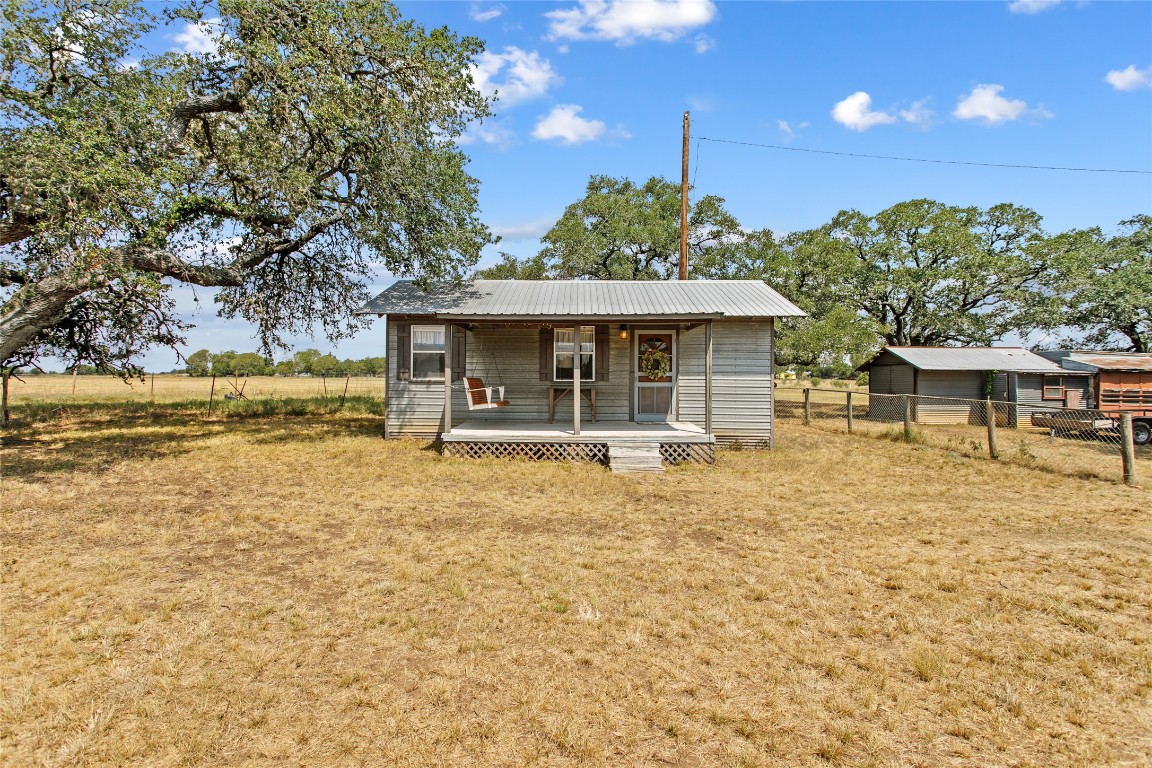 1408 State Park Road Lockhart, TX 78644 - Photo 5 of 38 a front view of a house with a garden