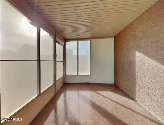 a view of a porch with wooden floor and iron walls