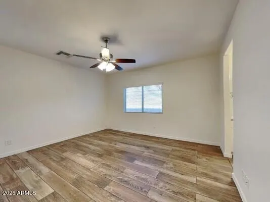 a view of a room with a ceiling fan and a window