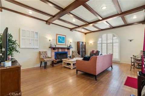 a dining room with furniture potted plants and wooden floor