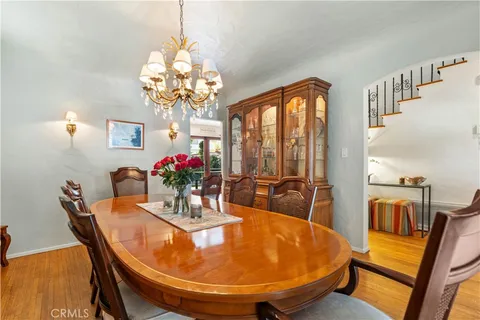 a kitchen with stainless steel appliances granite countertop table chairs sink and cabinets