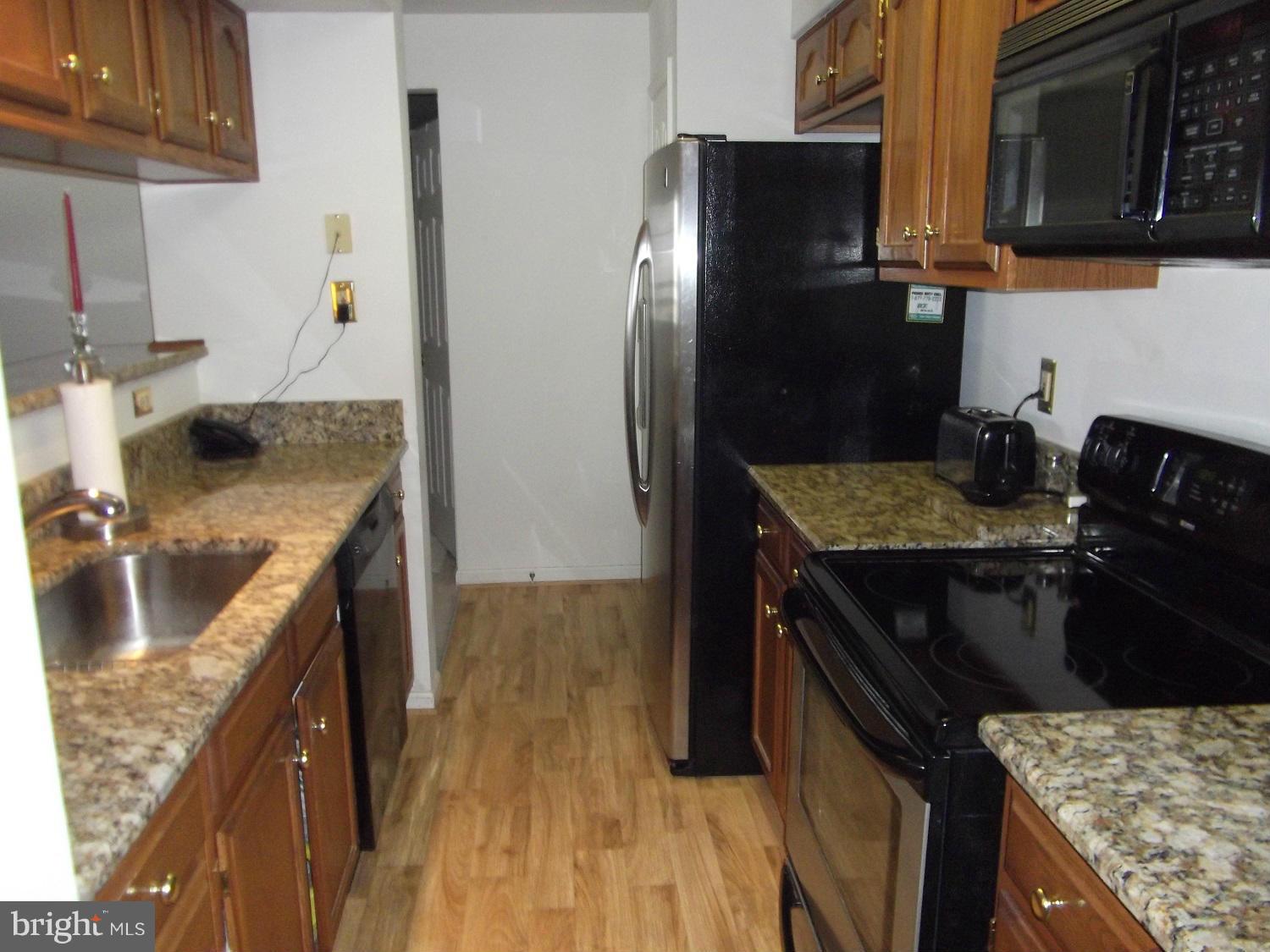 72 Laurel Path Court, Unit 3 Baltimore, MD 21236 - Photo 2 of 18 a kitchen with stainless steel appliances granite countertop a sink stove and refrigerator