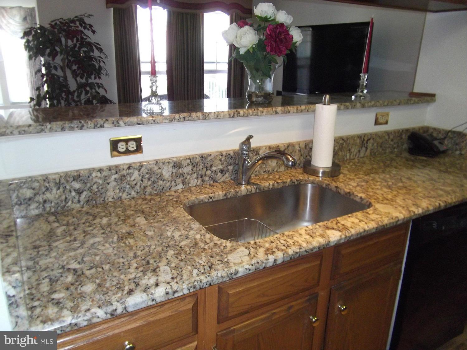 72 Laurel Path Court, Unit 3 Baltimore, MD 21236 - Photo 3 of 18 a kitchen with granite countertop a sink and a stove