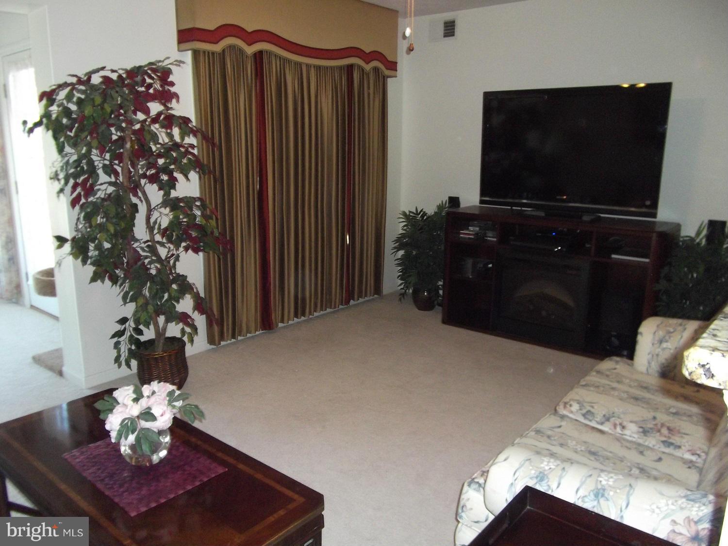 72 Laurel Path Court, Unit 3 Baltimore, MD 21236 - Photo 5 of 18 a living room with furniture and a flat screen tv