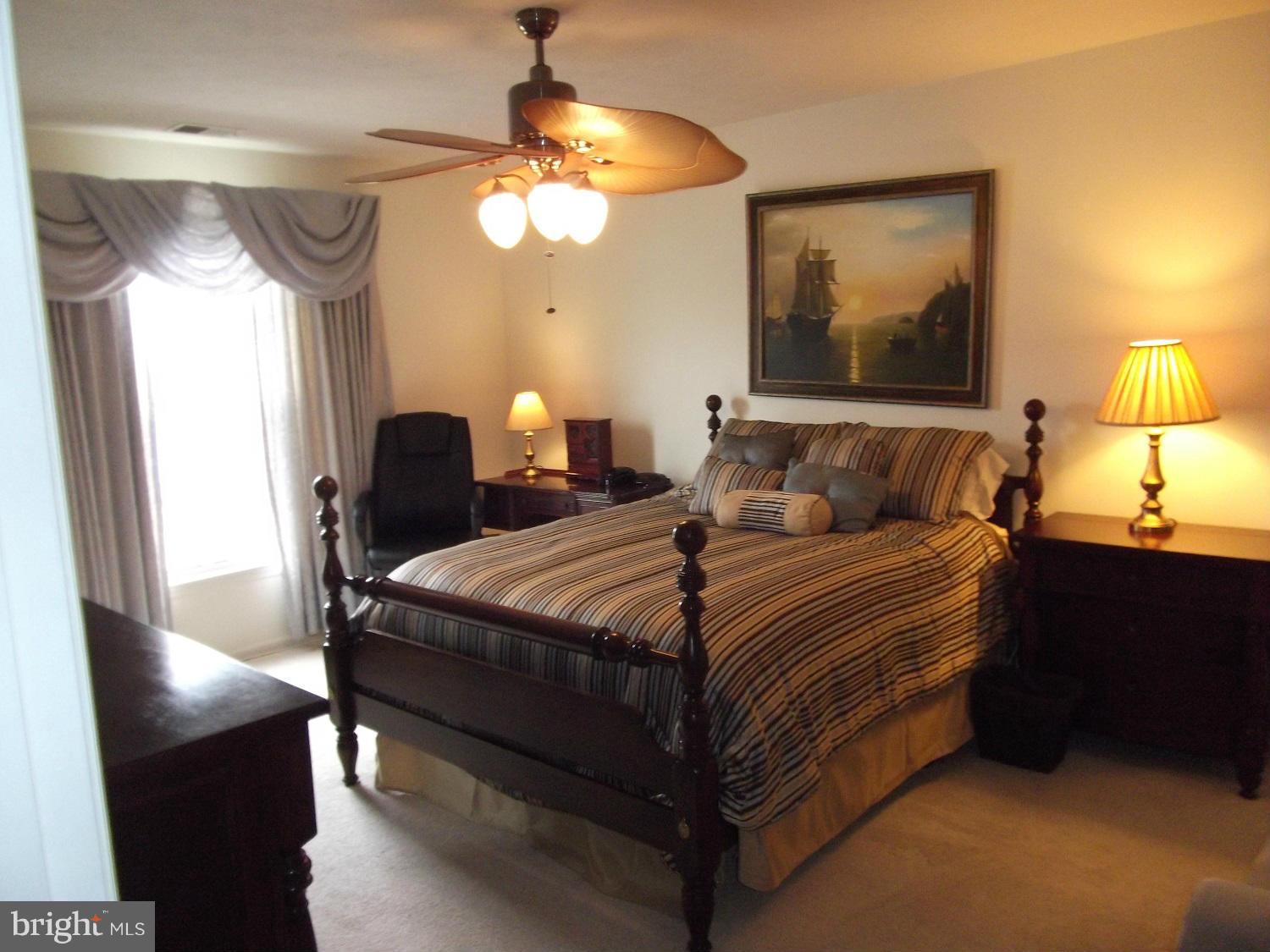 72 Laurel Path Court, Unit 3 Baltimore, MD 21236 - Photo 7 of 18 a bedroom with bed and a chandelier