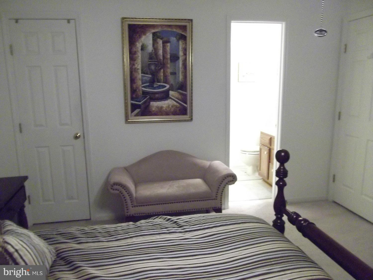 72 Laurel Path Court, Unit 3 Baltimore, MD 21236 - Photo 8 of 18 a bedroom with a bed and wooden floor