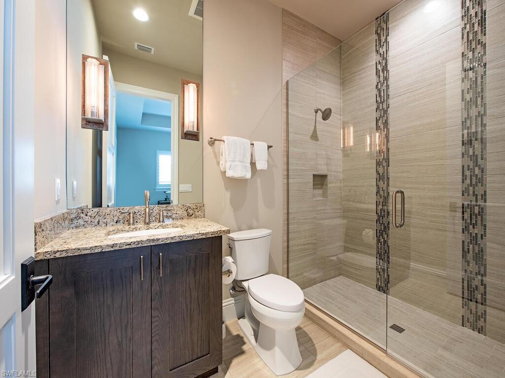 9200 Mercato Way Naples, FL 34108 - Photo 10 of 13 a bathroom with a granite countertop sink toilet and shower