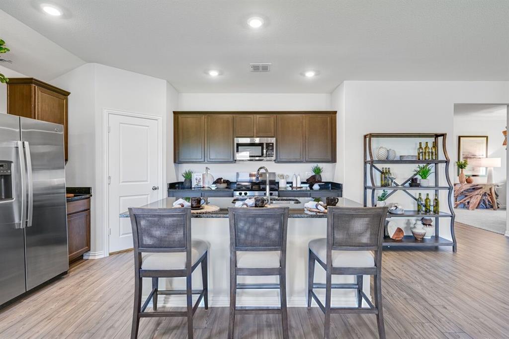 2621 Glacier Road Anna, TX 75409 - Photo 17 of 38 a kitchen with a table and chairs in it