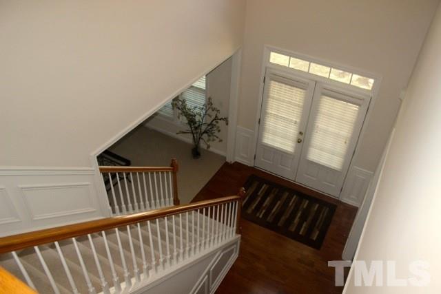 7729 Silver View Lane Raleigh, NC 27613 - Photo 2 of 25 a view of staircase with railing and white walls