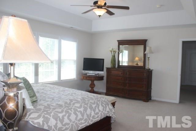 7729 Silver View Lane Raleigh, NC 27613 - Photo 13 of 25 a bedroom with a bed and a television