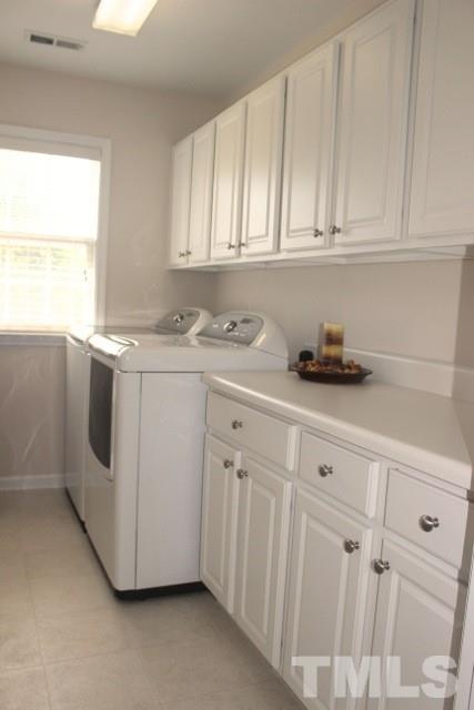 7729 Silver View Lane Raleigh, NC 27613 - Photo 16 of 25 a kitchen with white cabinets and white appliances