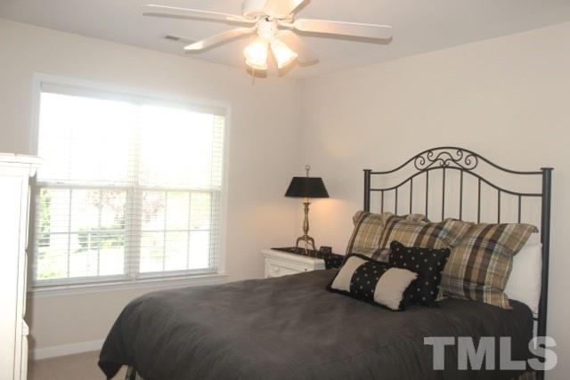 7729 Silver View Lane Raleigh, NC 27613 - Photo 18 of 25 a bedroom with a bed and a window