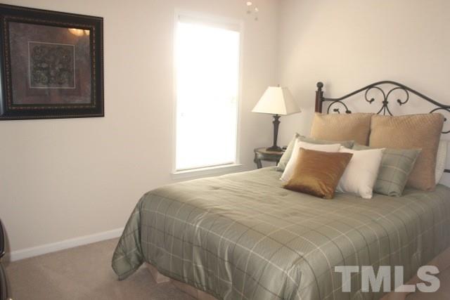 7729 Silver View Lane Raleigh, NC 27613 - Photo 19 of 25 a bedroom with bed and a night stand