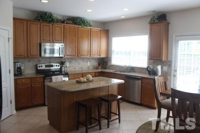 7729 Silver View Lane Raleigh, NC 27613 - Photo 5 of 25 a kitchen with a sink cabinets and window
