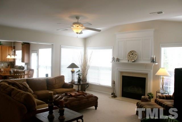 7729 Silver View Lane Raleigh, NC 27613 - Photo 9 of 25 a living room with furniture and a fireplace