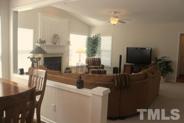 7729 Silver View Lane Raleigh, NC 27613 - Photo 10 of 25 a living room with furniture and a flat screen tv