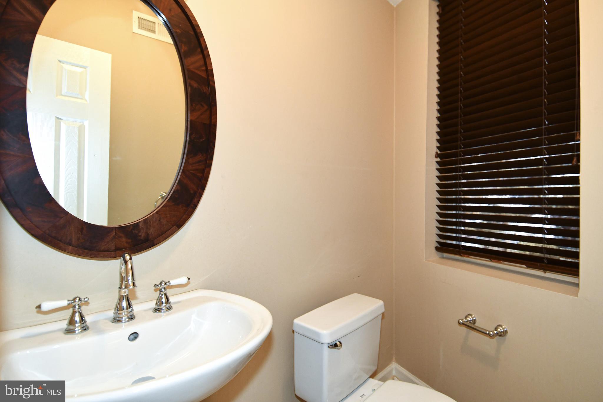 11 R Street Northwest Washington, DC 20001 - Photo 15 of 55 a bathroom with a sink a toilet and a mirror