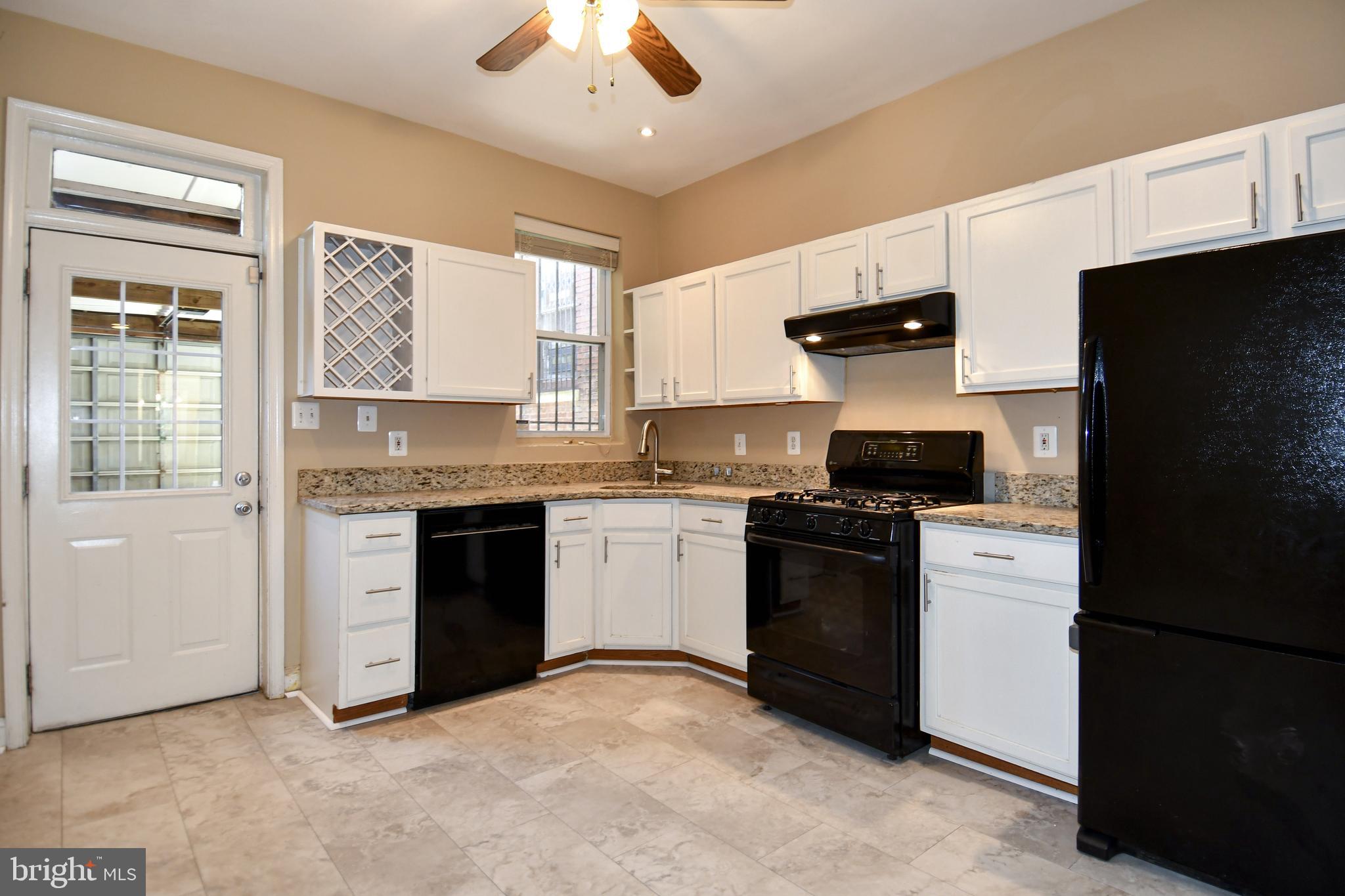 11 R Street Northwest Washington, DC 20001 - Photo 16 of 55 a kitchen with a stove and a refrigerator