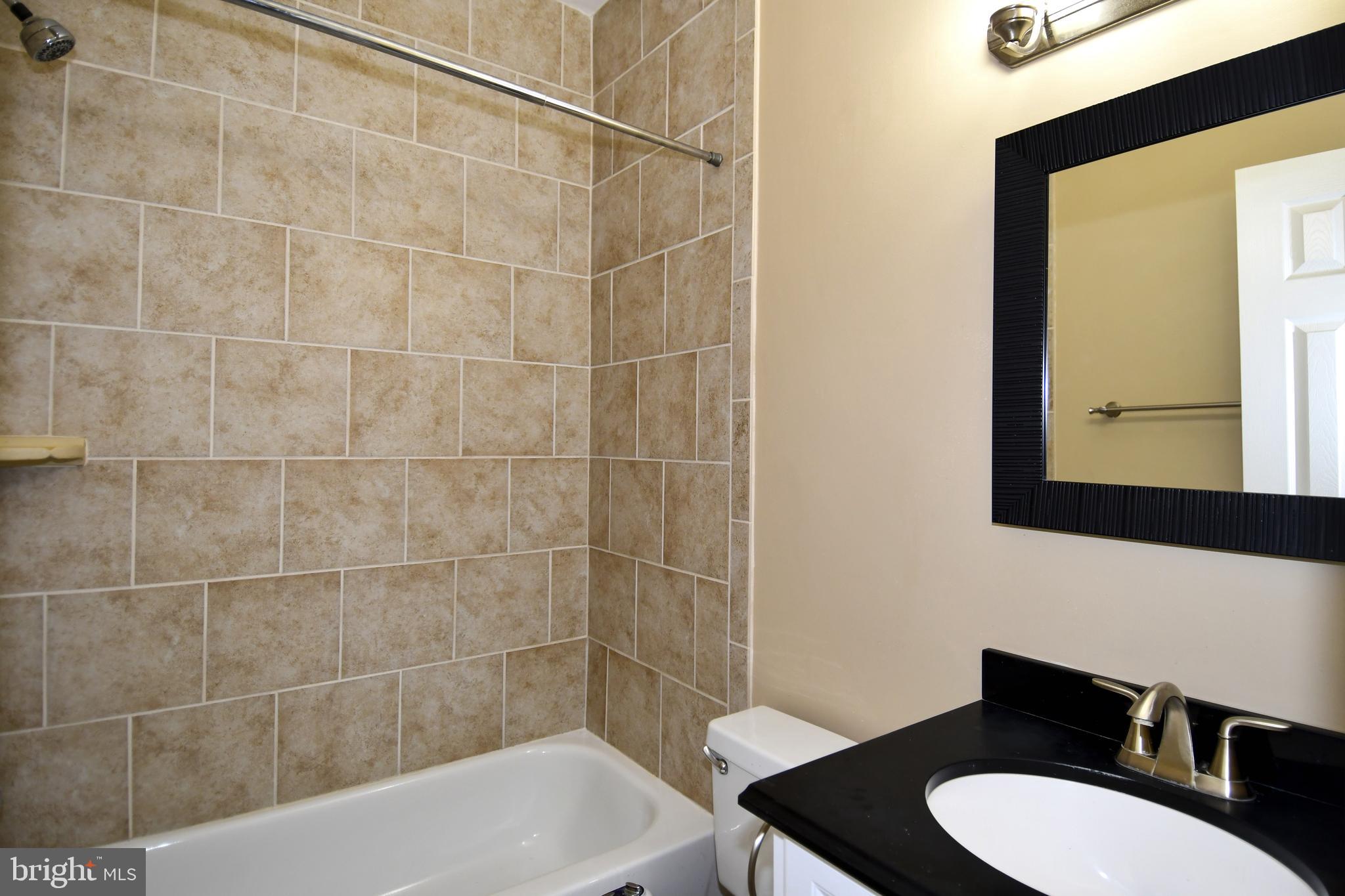 11 R Street Northwest Washington, DC 20001 - Photo 25 of 55 a bathroom with a sink a toilet and shower