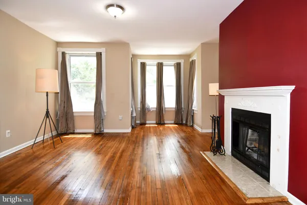 a bathroom with a granite countertop sink mirror vanity and toilet