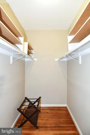 a kitchen with a wooden floor and white cabinets