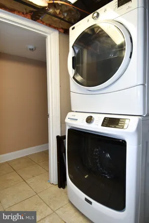 a view of the building with a bench in patio