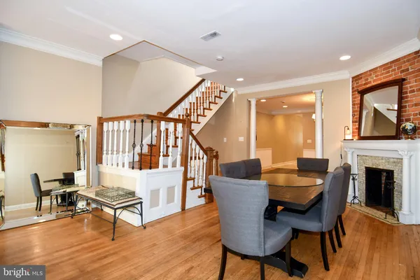 a living room with fireplace and a wooden floor