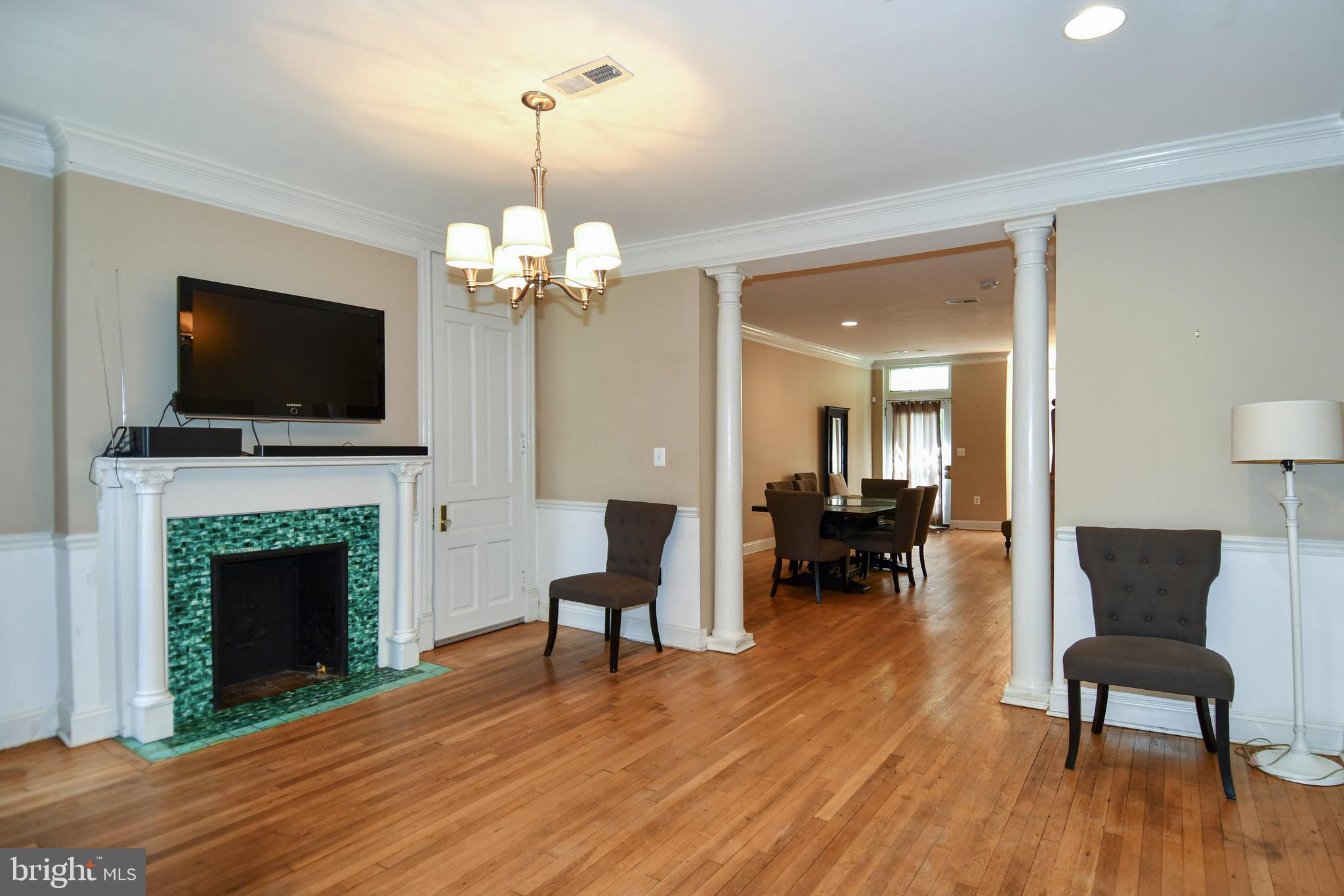 11 R Street Northwest Washington, DC 20001 - Photo 9 of 55 a living room with furniture a fireplace and a flat screen tv