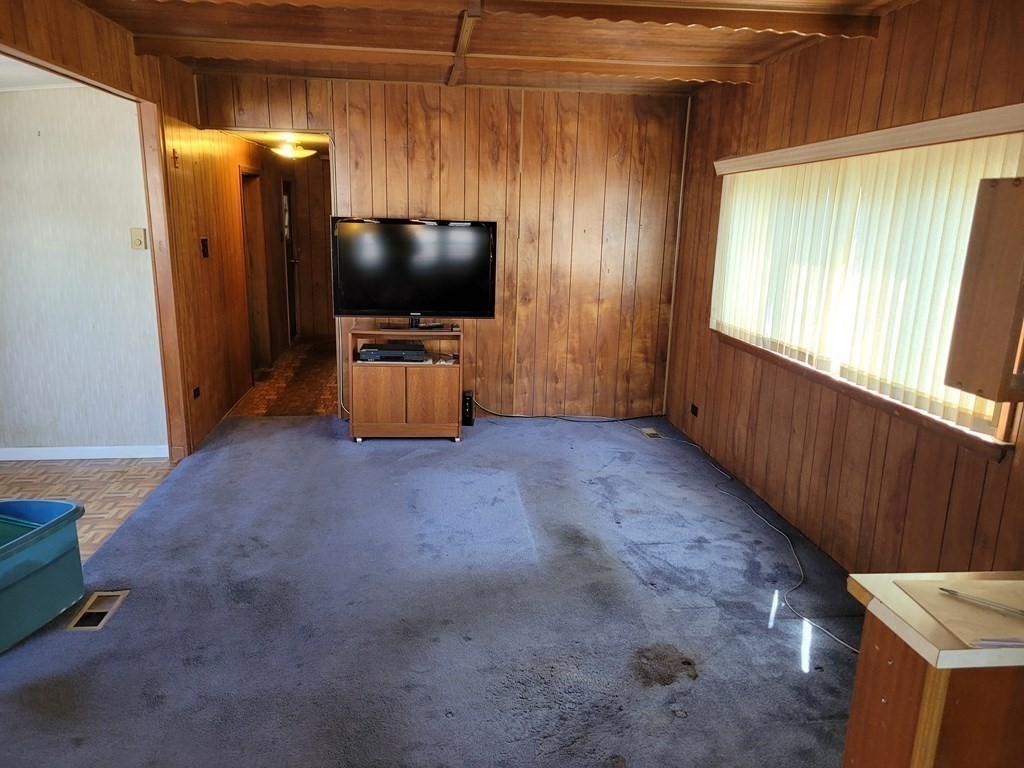 286 Newbury Street, Unit 75 Peabody, MA 01960 - Photo 4 of 18 a living room with furniture and a flat screen tv
