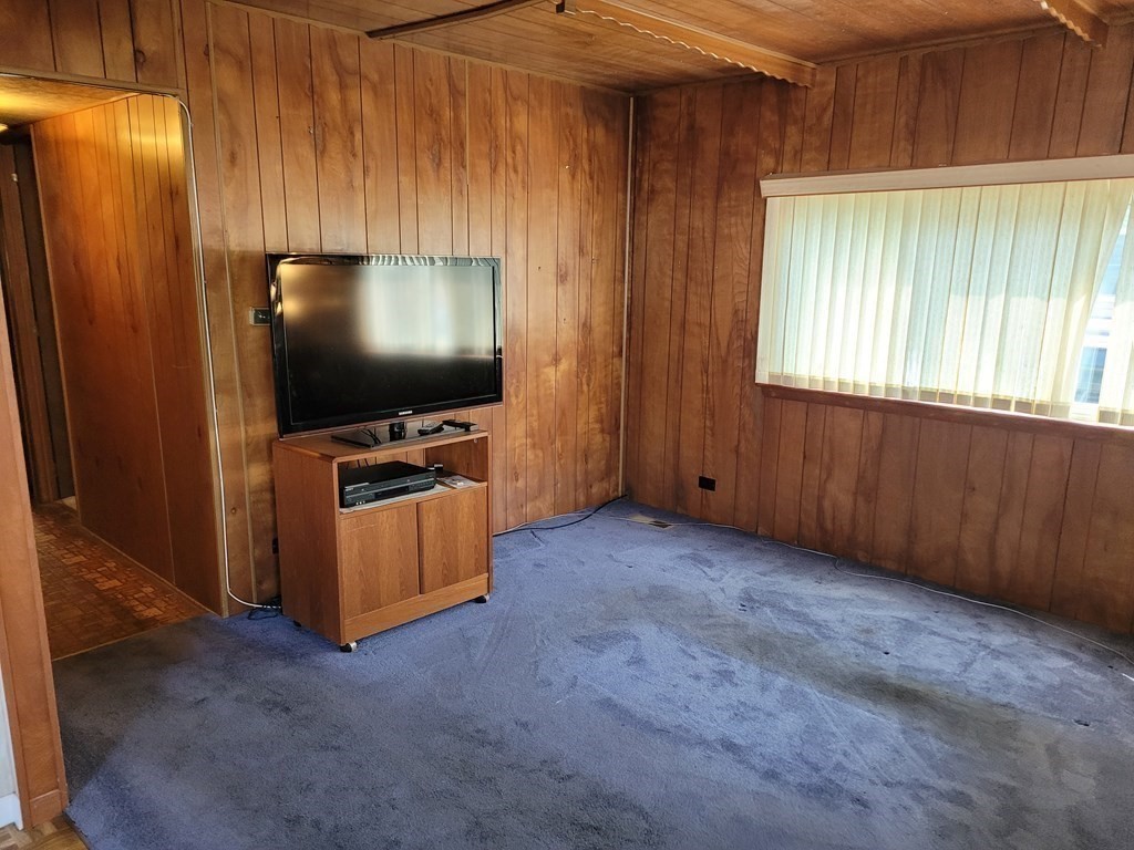 286 Newbury Street, Unit 75 Peabody, MA 01960 - Photo 8 of 18 a room with furniture and flat screen tv