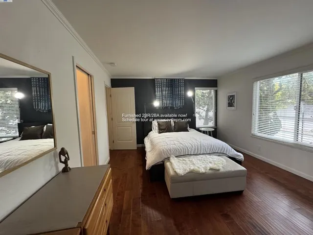 a spacious bedroom with a bed and window